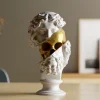 Bärtige Philosophen-Büste mit Blick auf ein goldenes Skelett darunter, PrintHero
